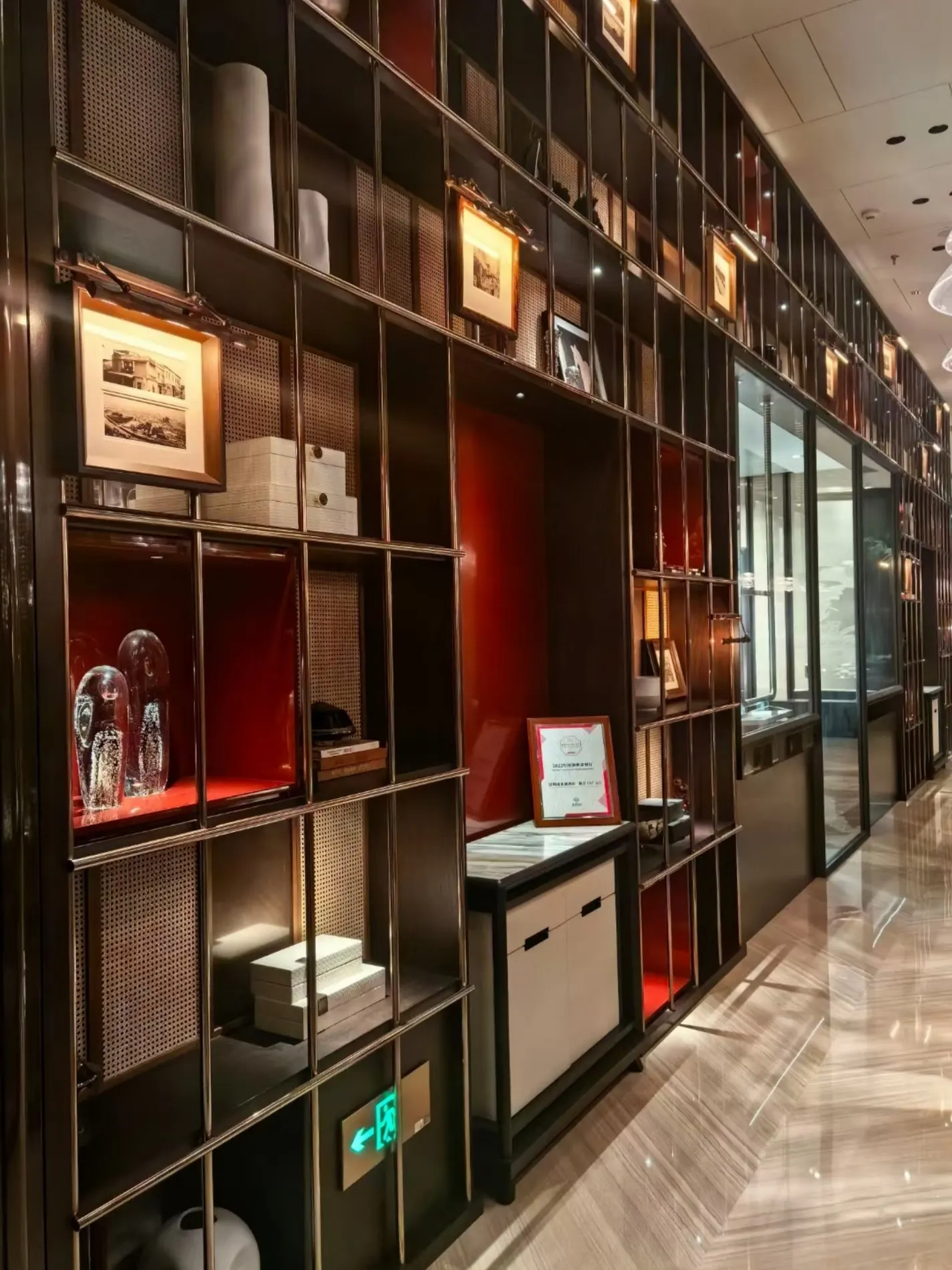 Bronze-toned metal display wall integrated into a commercial interior