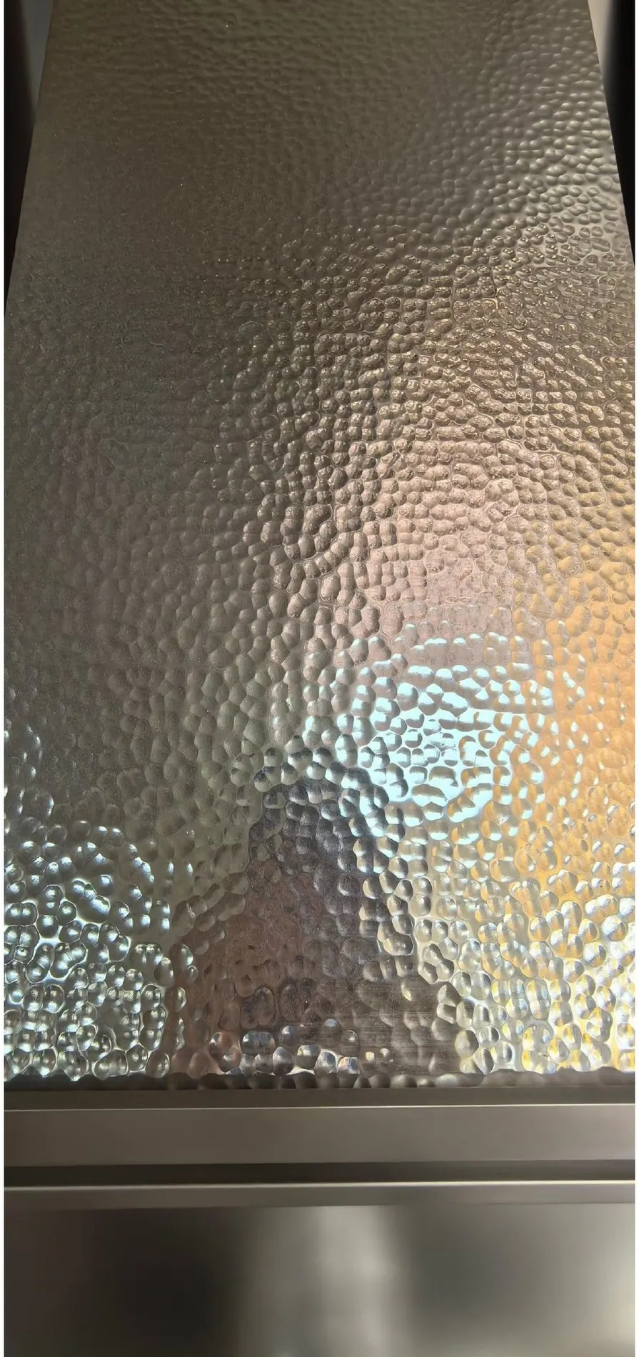 Close view of hand-hammered decorative metal texture