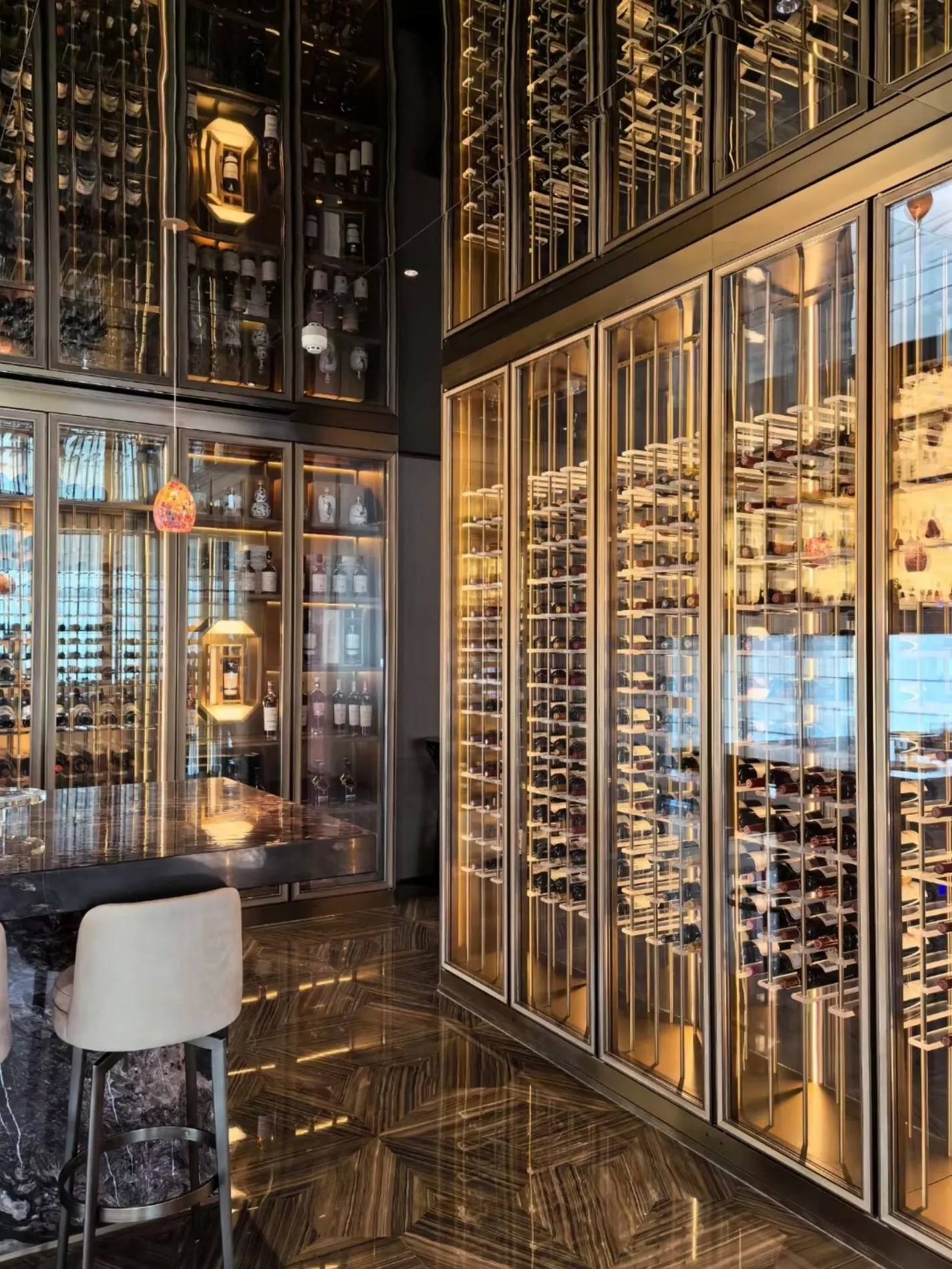 Floor-to-ceiling custom metal wine cellar and illuminated display system